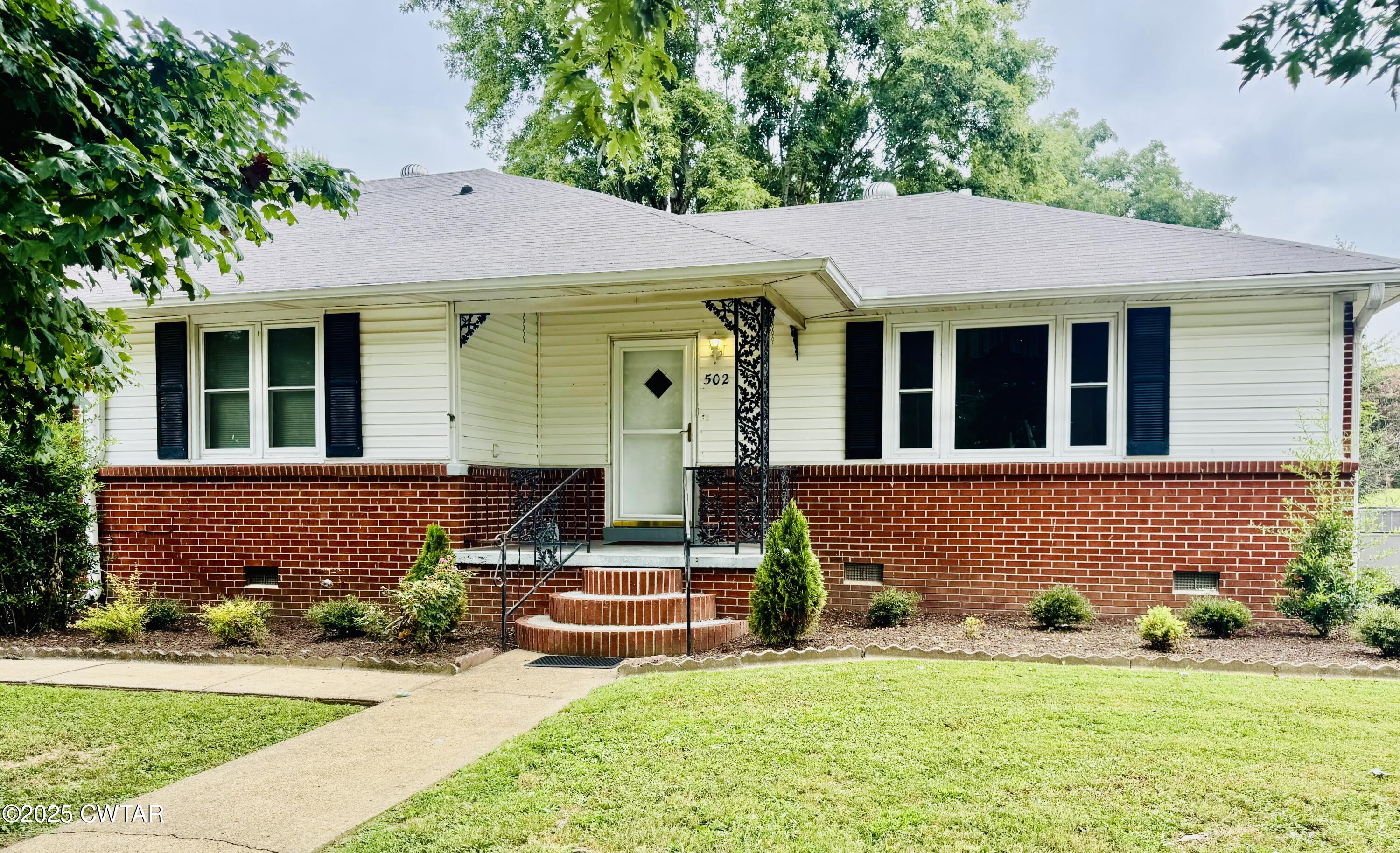 front view of a house with a yard