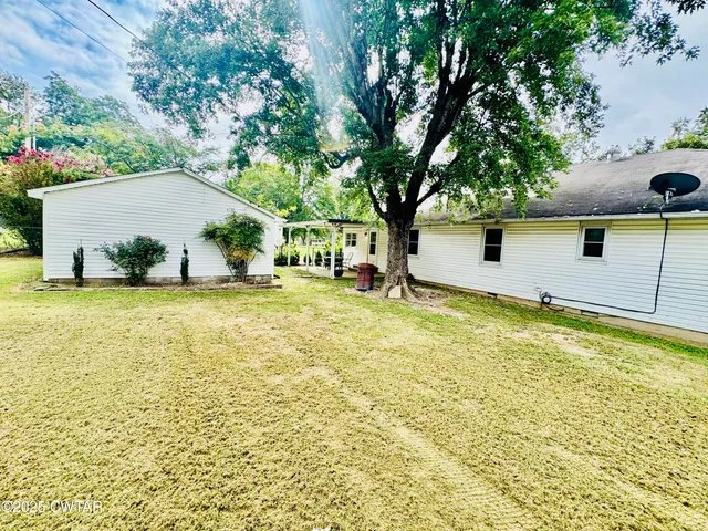a swimming pool with outdoor seating and yard
