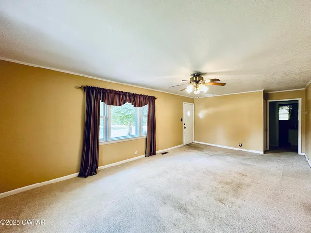 an empty room with a empty space and windows