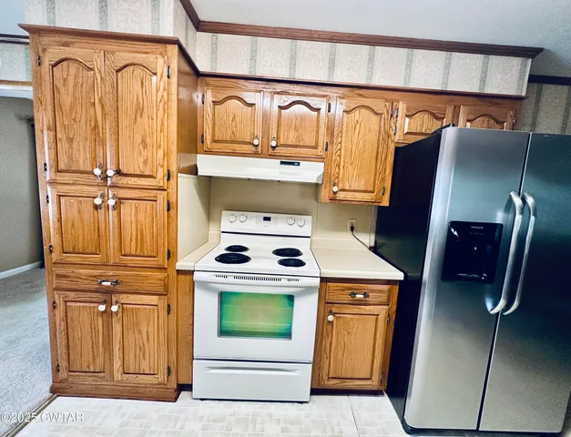 a kitchen with a stove and a refrigerator