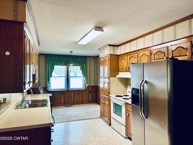 a kitchen with stainless steel appliances a refrigerator and a sink