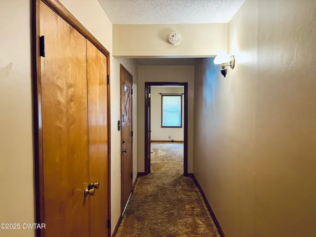 a view of a hallway with a door