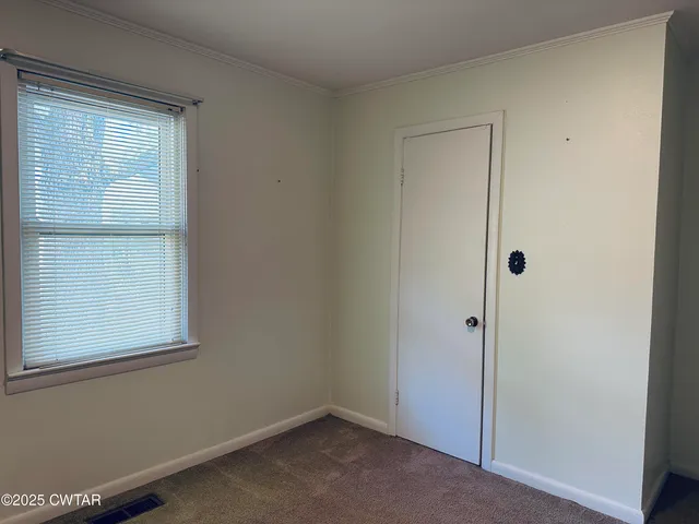 a bathroom with a granite countertop sink mirror vanity and toilet