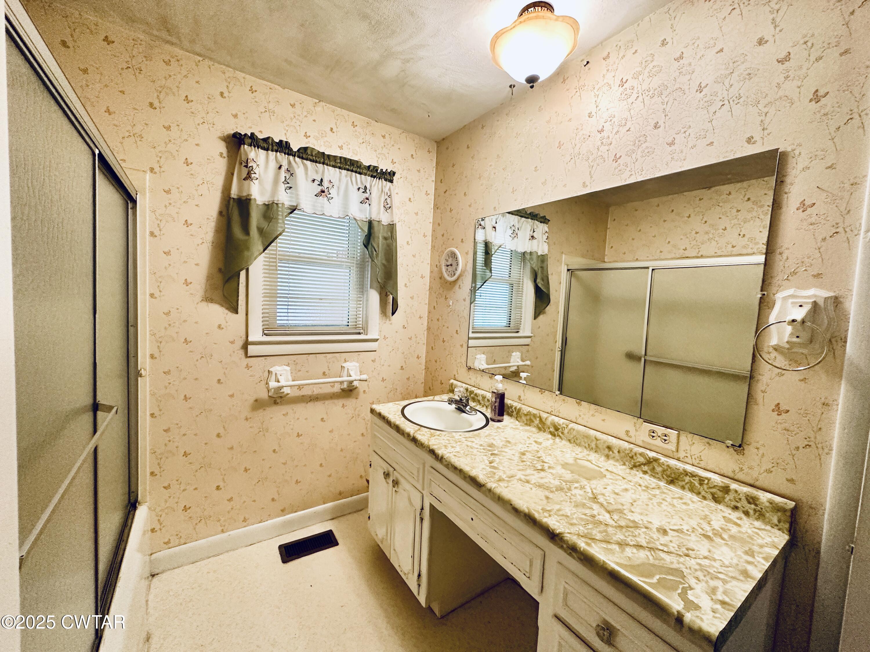 502 West Main Street Rutherford, TN 38369 - Photo 33 of 34 a bathroom with a granite countertop sink a mirror and shower