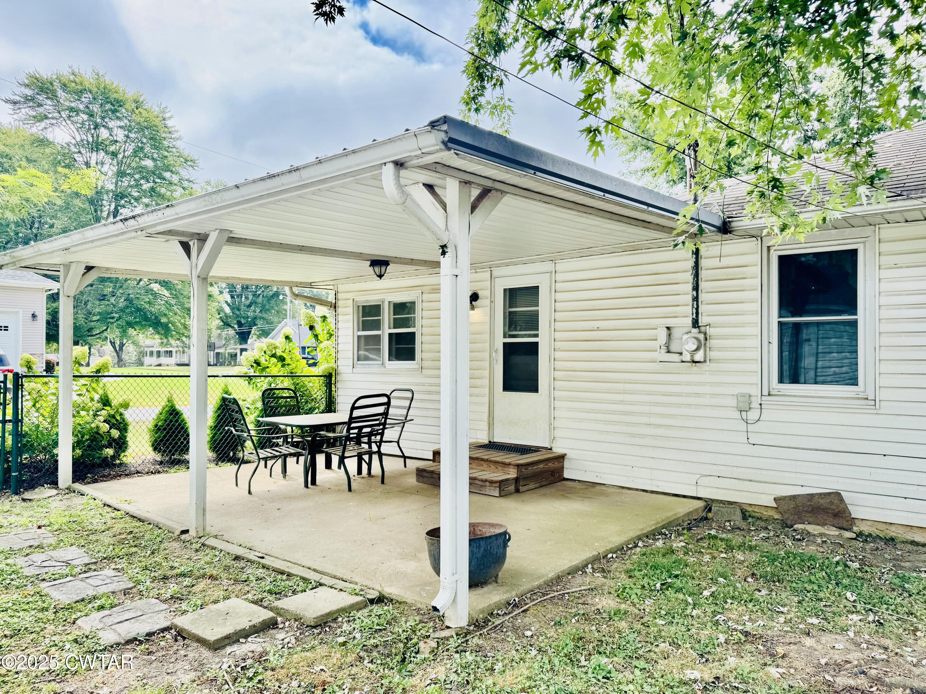 502 West Main Street Rutherford, TN 38369 - Photo 10 of 34 a view of a patio with table and chairs potted plants and floor to ceiling window