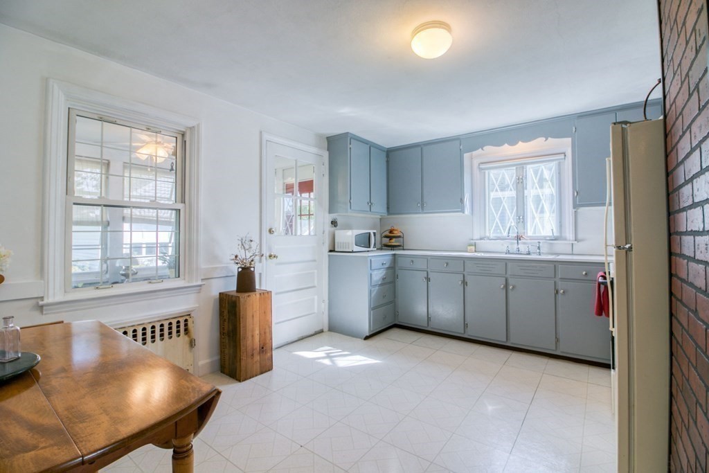 29 Harkness Avenue Springfield, MA 01118 - Photo 8 of 18 a kitchen with cabinets a sink a counter space and a window