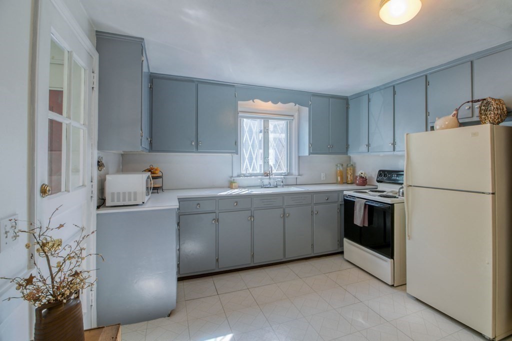 29 Harkness Avenue Springfield, MA 01118 - Photo 9 of 18 a kitchen with a sink stove and refrigerator