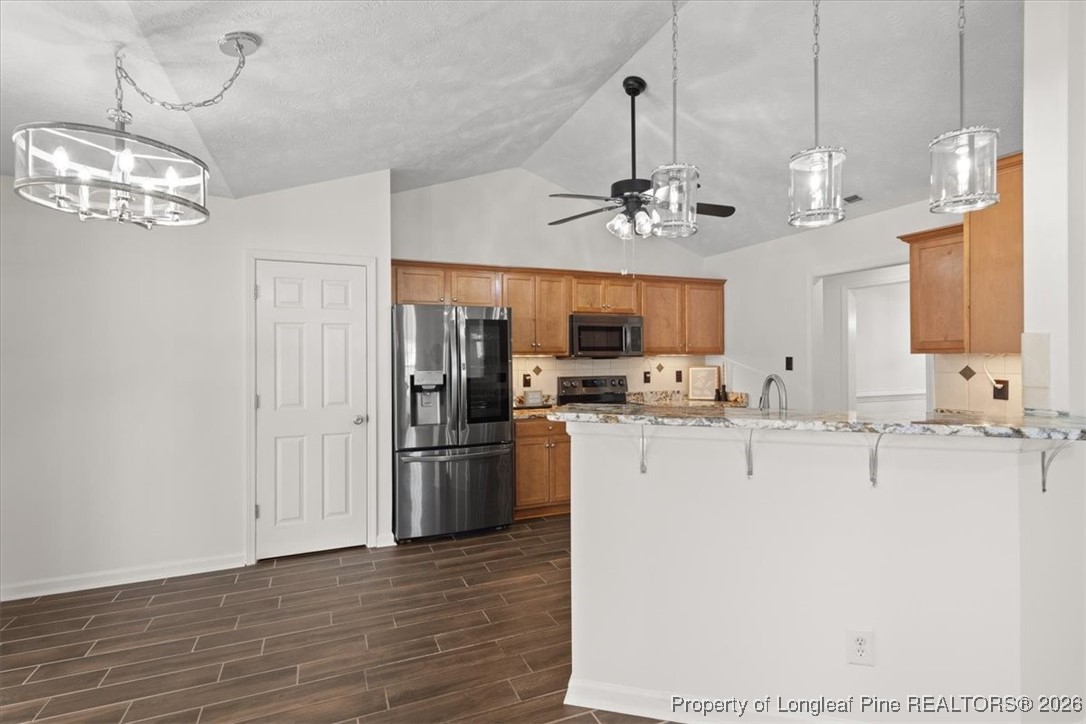 6649 Hillbrook Road Hope Mills, NC 28348 - Photo 14 of 37 a view of a kitchen with stainless steel appliances granite countertop cabinets and a chandelier
