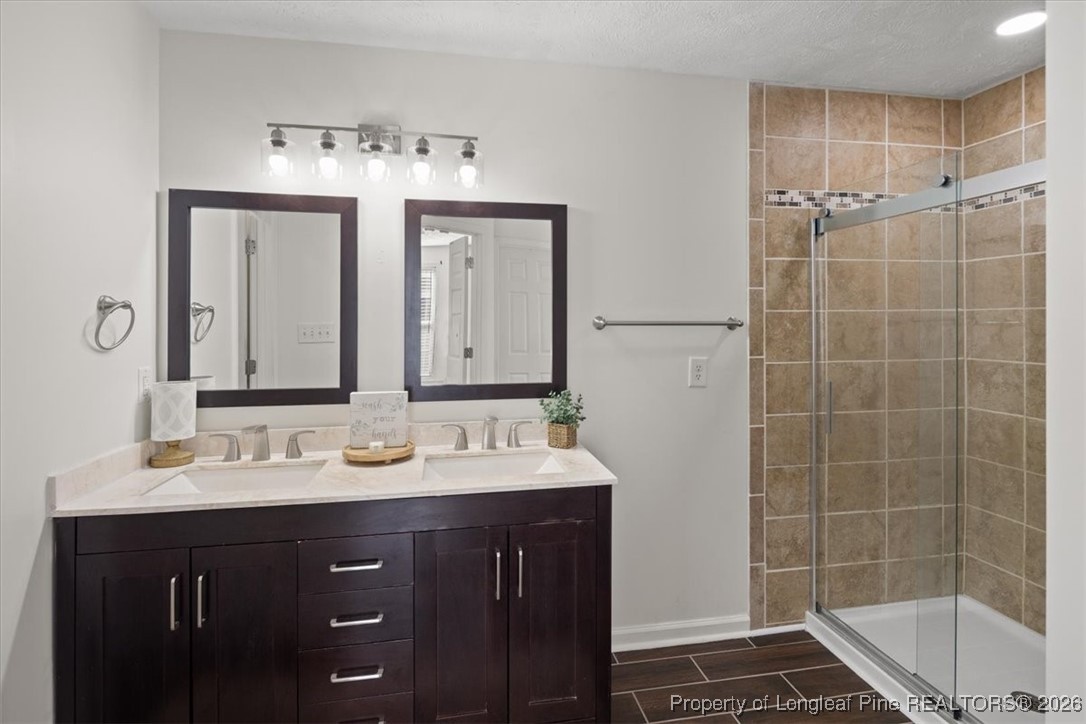 6649 Hillbrook Road Hope Mills, NC 28348 - Photo 20 of 37 a bathroom with a double vanity sink mirror and