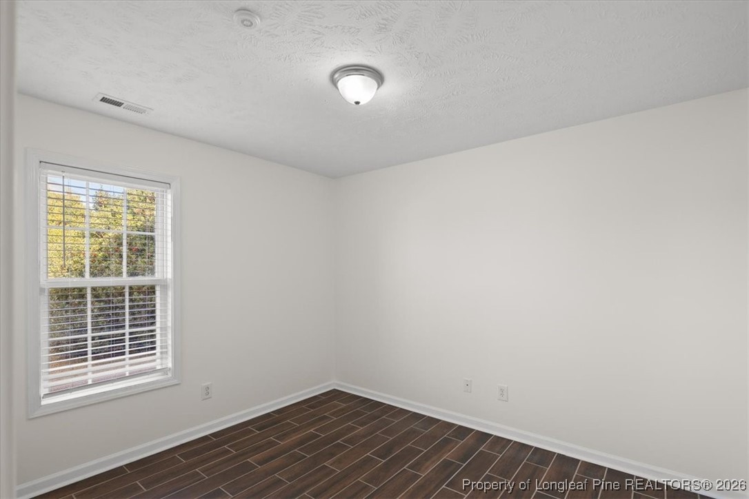6649 Hillbrook Road Hope Mills, NC 28348 - Photo 27 of 37 a view of an empty room with wooden floor and a window