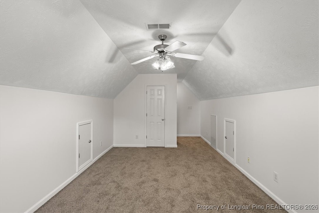 6649 Hillbrook Road Hope Mills, NC 28348 - Photo 31 of 37 an empty room with a chandelier fan and windows