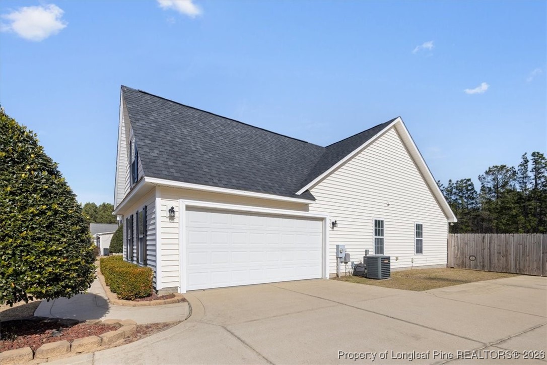 6649 Hillbrook Road Hope Mills, NC 28348 - Photo 4 of 37 a view of a house with a yard and a garage