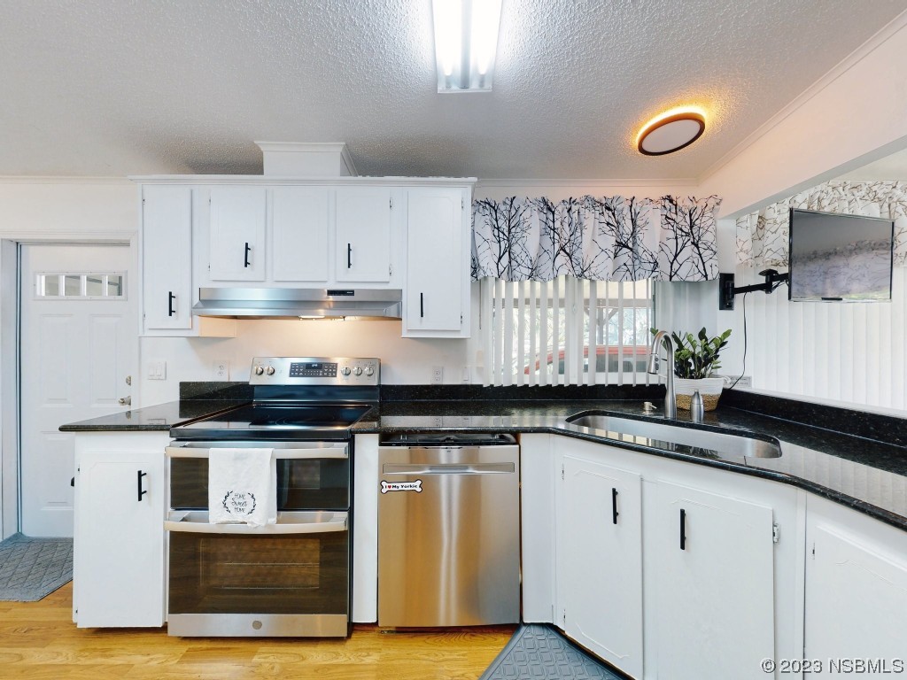 503 Halyard Circle Edgewater, FL 32141 - Photo 10 of 50 a kitchen with granite countertop a sink stainless steel appliances and cabinets