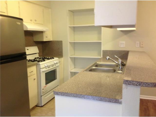 1601 Rutland Drive, Unit A Austin, TX 78758 - Photo 2 of 7 a kitchen with a sink stove and cabinets