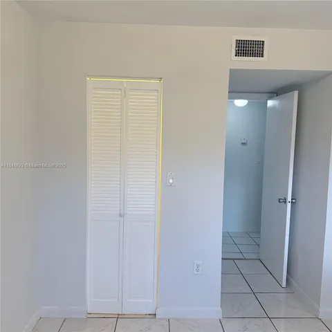a view of a closet area with an empty room