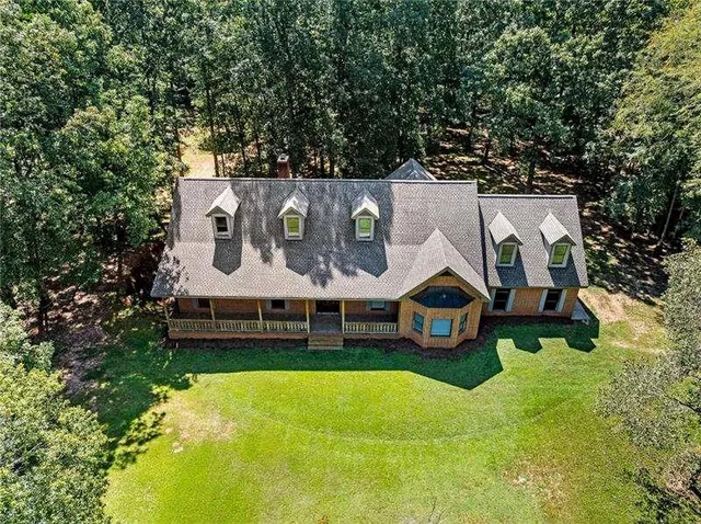 an aerial view of residential houses with outdoor space and street view