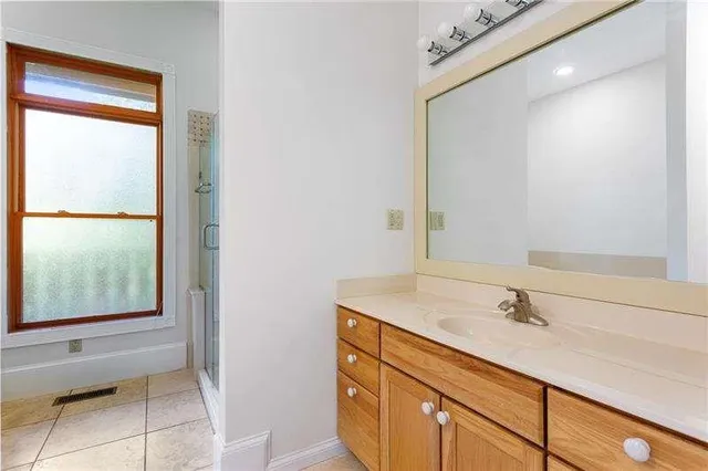 a backyard of a house with large trees and brick walls