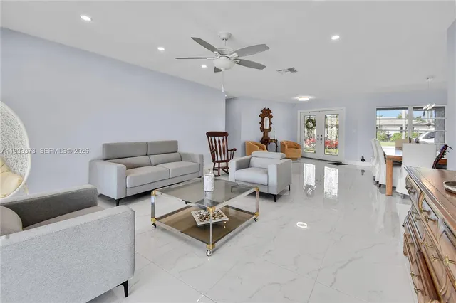 a living room with furniture and a large window