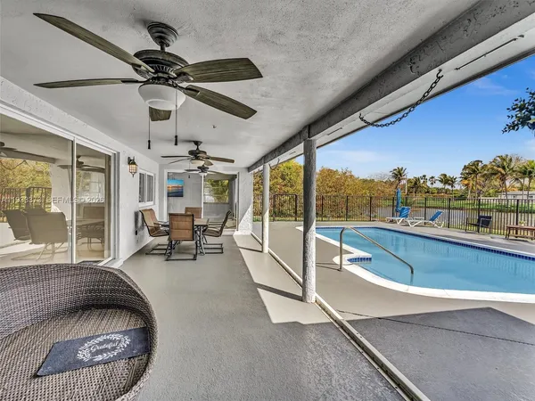 a kitchen with stainless steel appliances granite countertop a stove top oven a sink a refrigerator and white cabinets