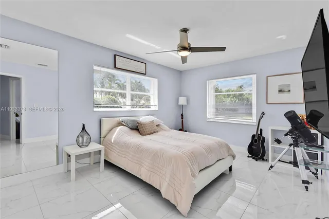 a bedroom with a bed chair and window