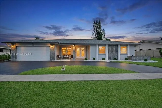 a front view of a house with garden