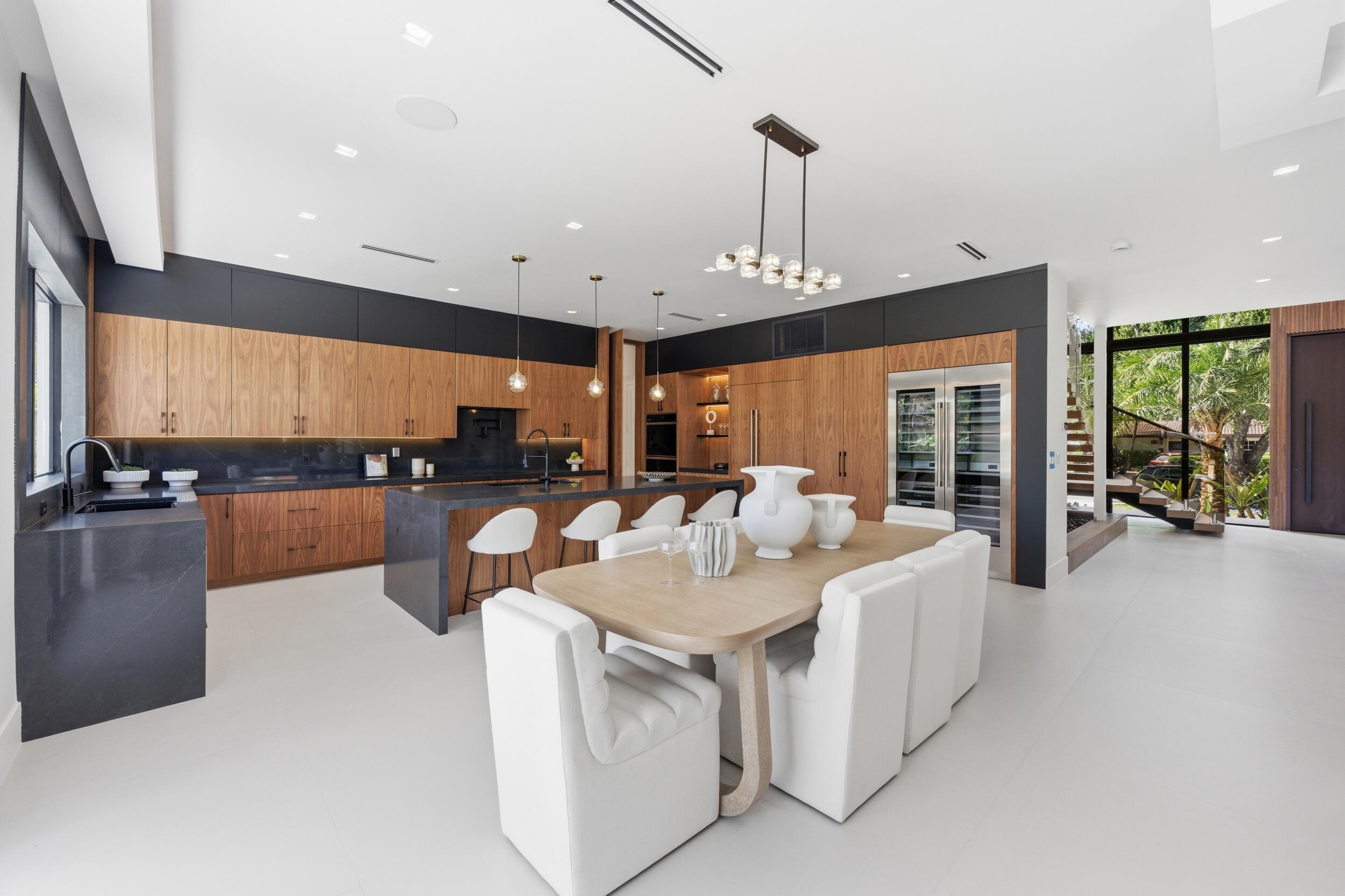 2360 Northeast 49th Street Lighthouse Point, FL 33064 - Photo 11 of 66 a large kitchen with a large counter top appliances and a chandelier