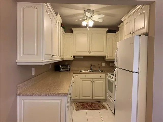 a kitchen with stainless steel appliances a stove a refrigerator and cabinets