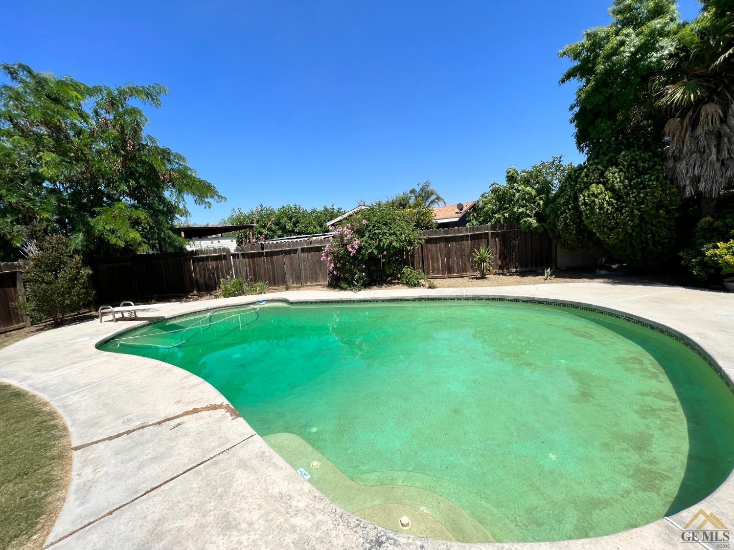 Undisclosed Address Wasco, CA 93280 - Photo 16 of 17 a view of a swimming pool with a garden
