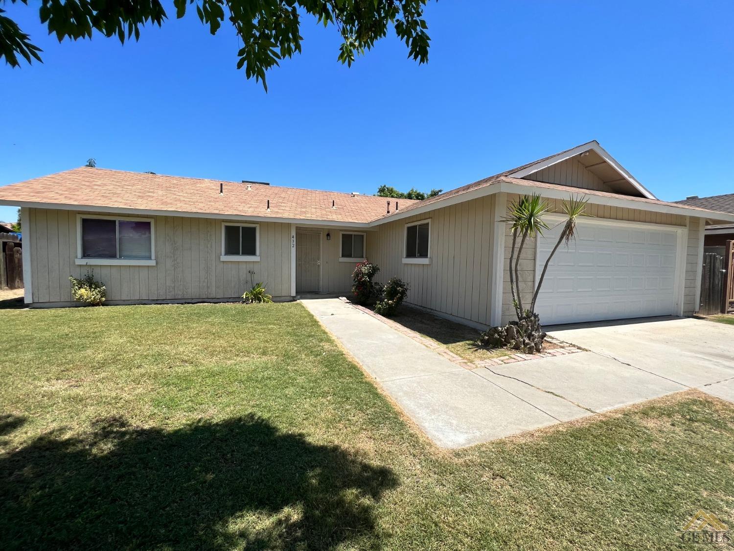 Undisclosed Address Wasco, CA 93280 - Photo 2 of 17 a front view of house with yard and trees in the background