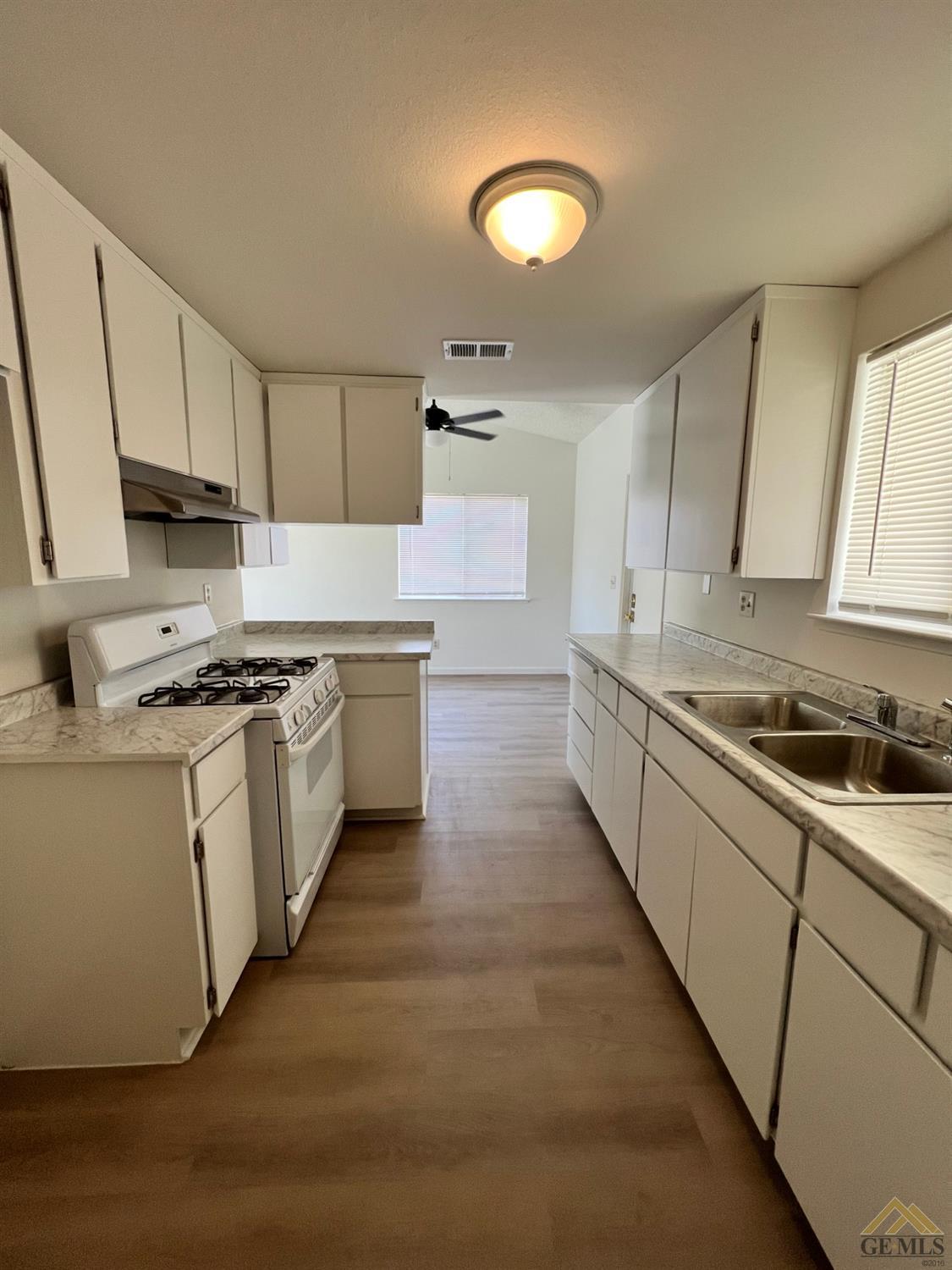 Undisclosed Address Wasco, CA 93280 - Photo 3 of 17 a kitchen with granite countertop white cabinets and white appliances