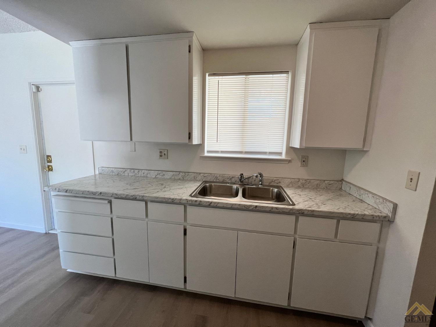 Undisclosed Address Wasco, CA 93280 - Photo 6 of 17 a kitchen with a sink and cabinets