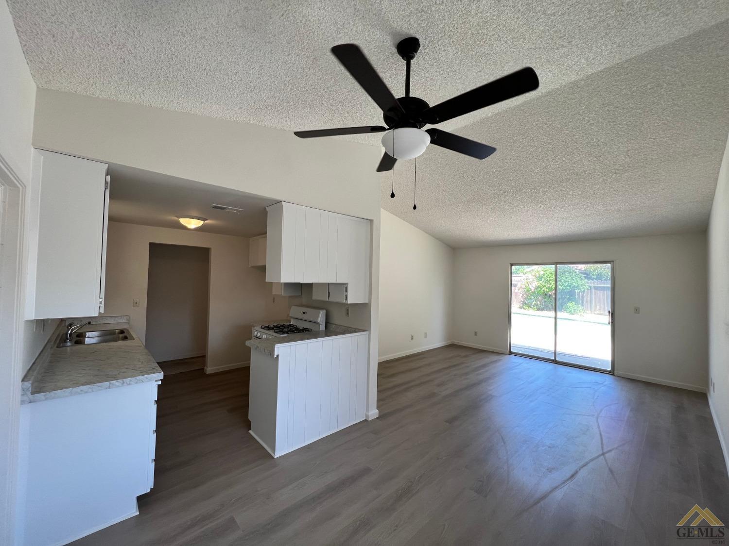 Undisclosed Address Wasco, CA 93280 - Photo 7 of 17 a living room with wooden floor and furniture