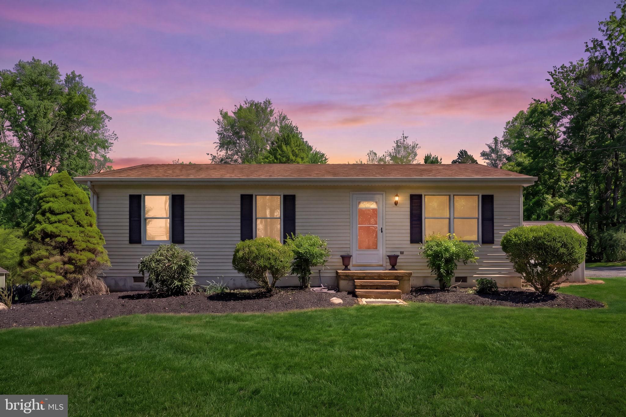 a view of a house with a yard and plants