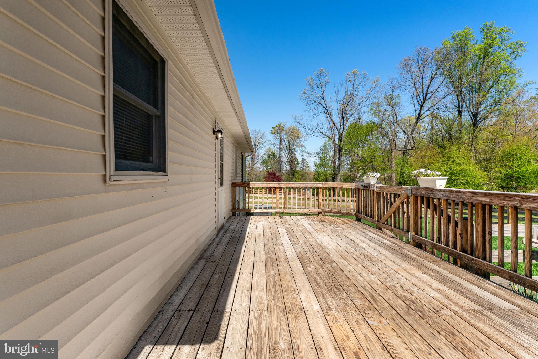 9283 Springs Road Warrenton, VA 20186 - Photo 13 of 18 a view of balcony with wooden floor and fence