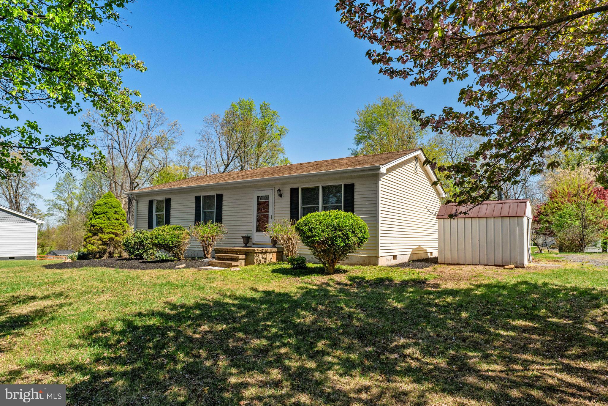 9283 Springs Road Warrenton, VA 20186 - Photo 17 of 18 a front view of house with yard outdoor seating and green space