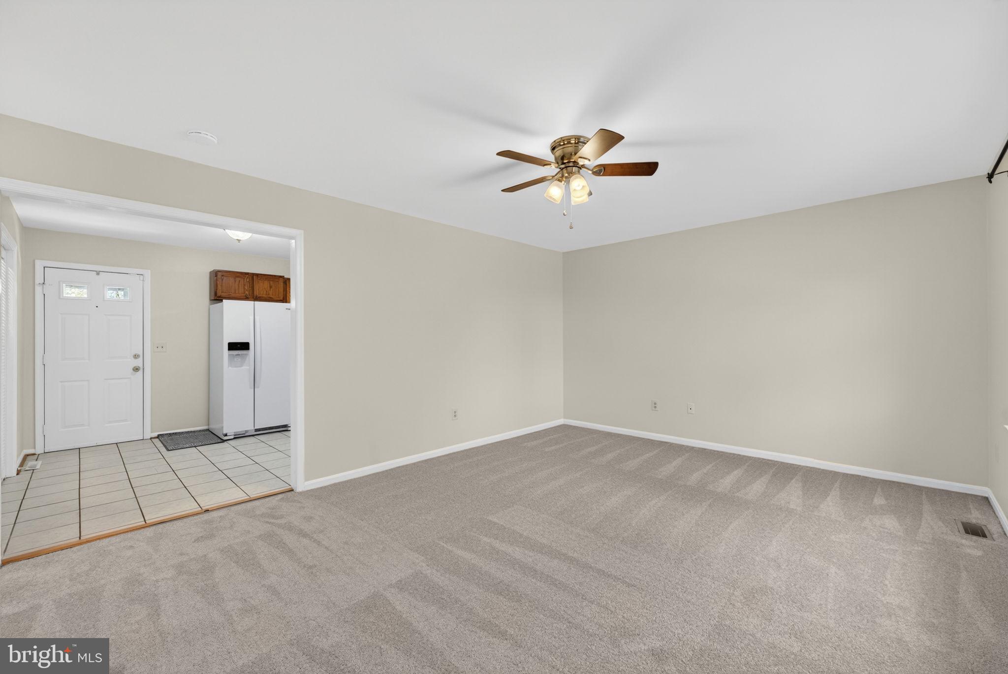 9283 Springs Road Warrenton, VA 20186 - Photo 2 of 18 an empty room with a empty space and a ceiling fan