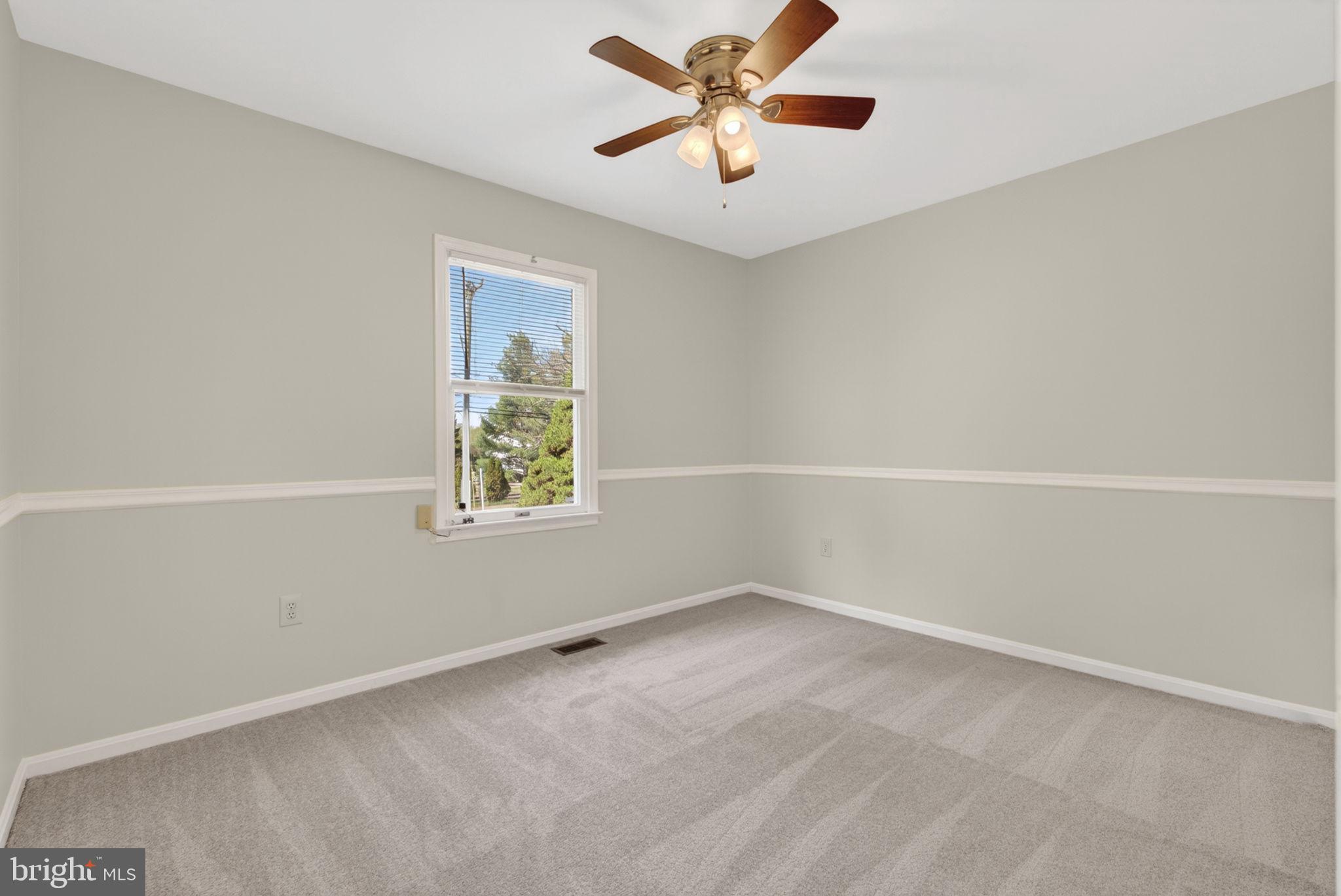 9283 Springs Road Warrenton, VA 20186 - Photo 6 of 18 an empty room with a window and a fan