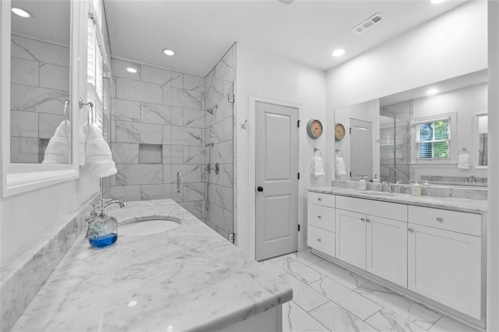 518 Bismark Road Northeast Atlanta, GA 30324 - Photo 17 of 23 a bathroom with a granite countertop sink a toilet and shower