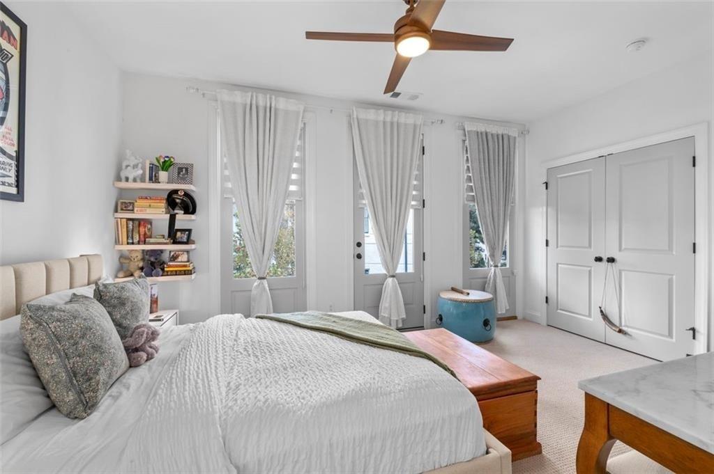 518 Bismark Road Northeast Atlanta, GA 30324 - Photo 19 of 23 a spacious bedroom with a bed and a chandelier