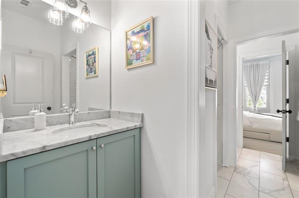 518 Bismark Road Northeast Atlanta, GA 30324 - Photo 20 of 23 a bathroom with a granite countertop sink a mirror and a vanity