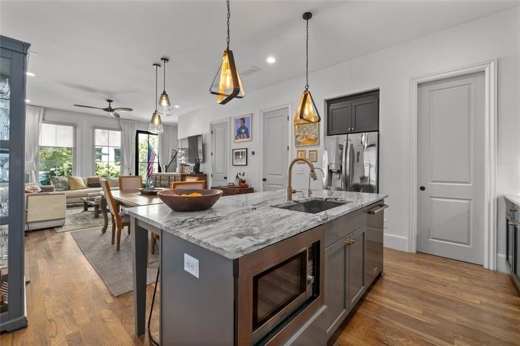 518 Bismark Road Northeast Atlanta, GA 30324 - Photo 6 of 23 a kitchen with stainless steel appliances granite countertop a sink a stove and a wooden floors