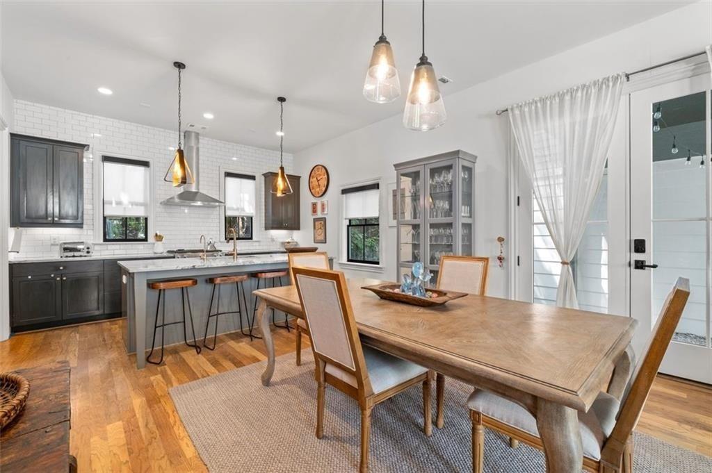 518 Bismark Road Northeast Atlanta, GA 30324 - Photo 8 of 23 a kitchen with stainless steel appliances granite countertop a kitchen island a stove a table and chairs