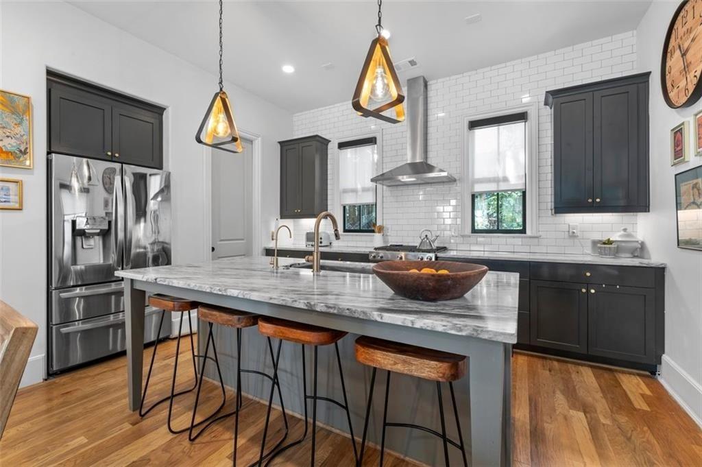 518 Bismark Road Northeast Atlanta, GA 30324 - Photo 10 of 23 a kitchen with stainless steel appliances a sink a stove a refrigerator and cabinets