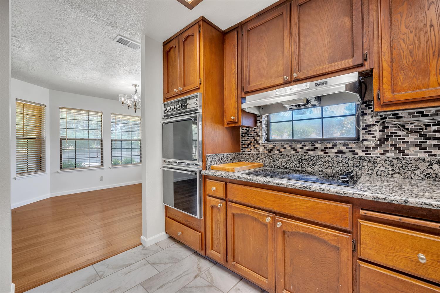 5990 Barton Road Loomis, CA 95650 - Photo 14 of 67 a kitchen with stainless steel appliances granite countertop a sink stove and cabinets