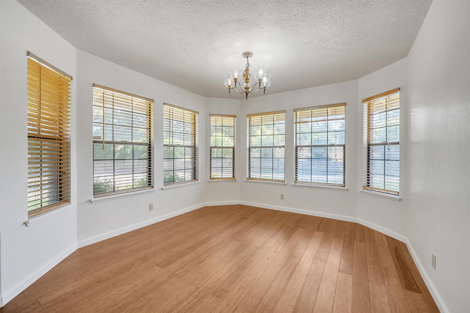 5990 Barton Road Loomis, CA 95650 - Photo 16 of 67 a view of an empty room with wooden floor and a window