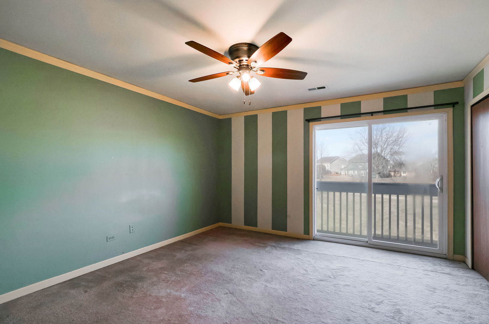 17475 Chestnut Lane Gurnee, IL 60031 - Photo 7 of 17 an empty room with windows and fan