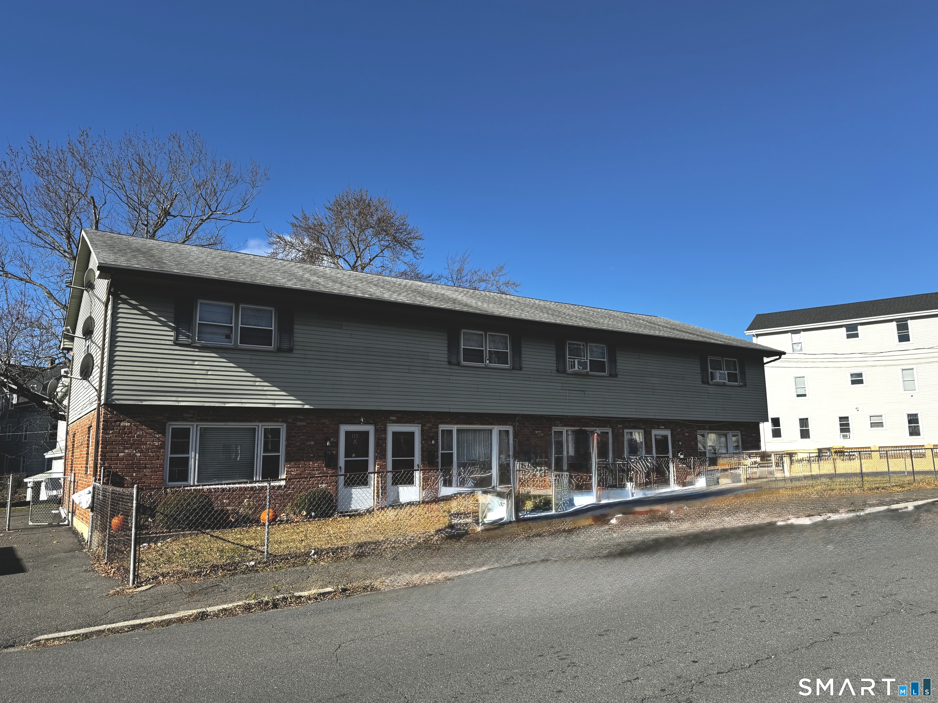 a view of a house with parking space and a car parked beside it
