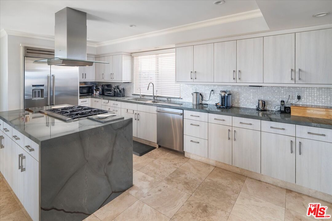 1975 Deermont Road Glendale, CA 91207 - Photo 11 of 42 a kitchen with stainless steel appliances granite countertop a sink stove refrigerator and cabinets