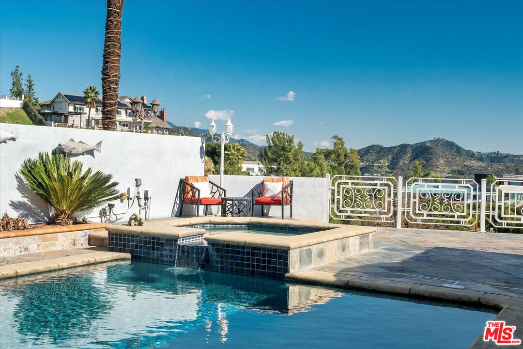 1975 Deermont Road Glendale, CA 91207 - Photo 18 of 42 a view of a house with swimming pool outdoor seating