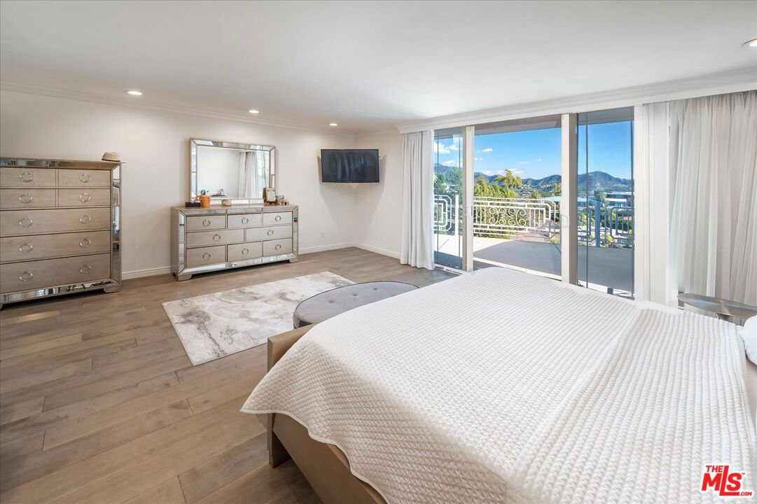 1975 Deermont Road Glendale, CA 91207 - Photo 23 of 42 a spacious bedroom with a large bed and a view of bedroom